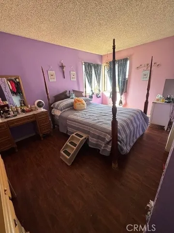 a bed room with a bed and a chair