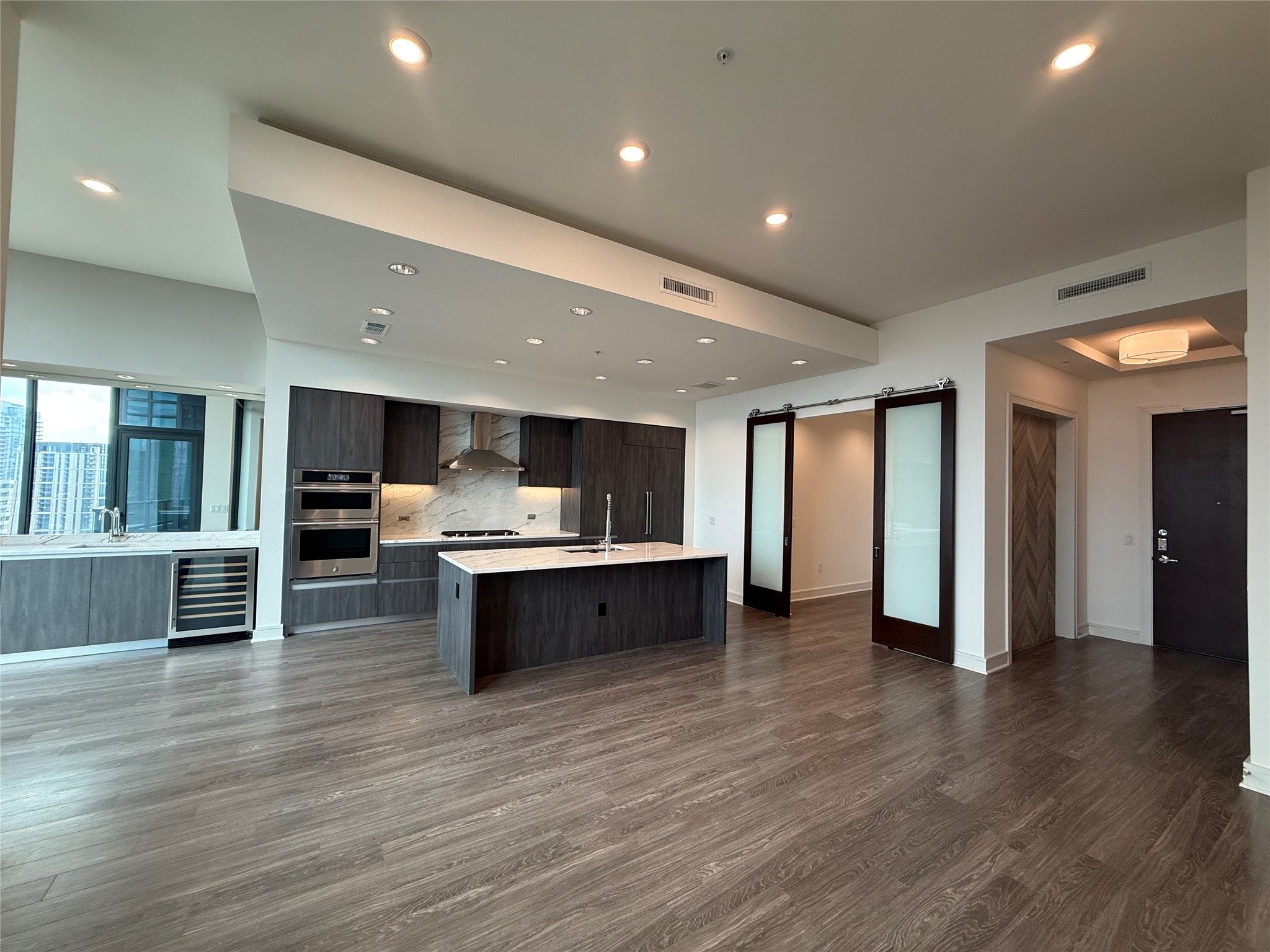 2525 Turtle Creek Boulevard, Unit 2002 Dallas, TX 75219 - Photo 5 of 8 a large kitchen with stainless steel appliances granite countertop a large counter top a sink and a stove