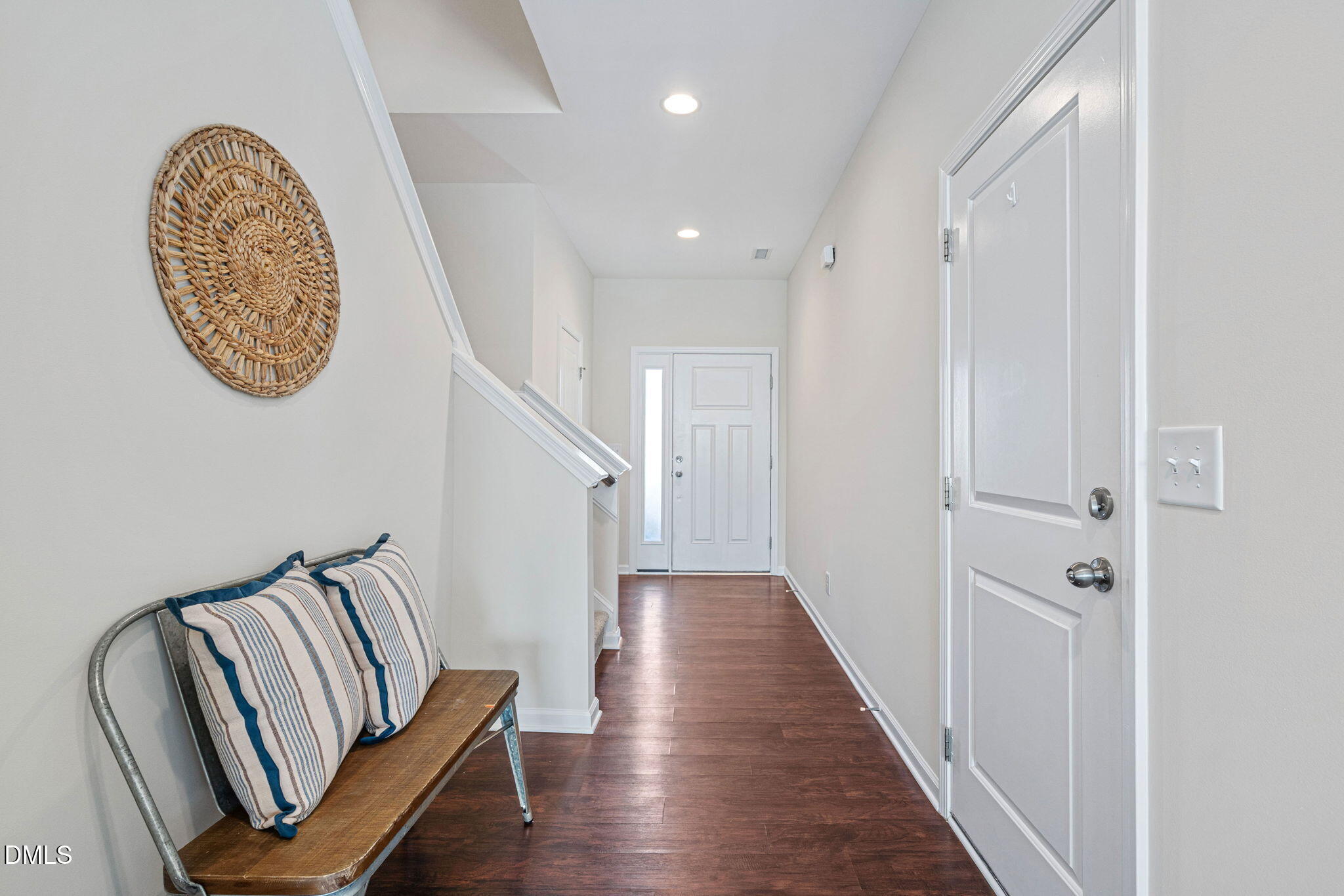 107 Ransomwood Drive Apex, NC 27539 - Photo 11 of 42 a view of a hallway with wooden floor and staircase