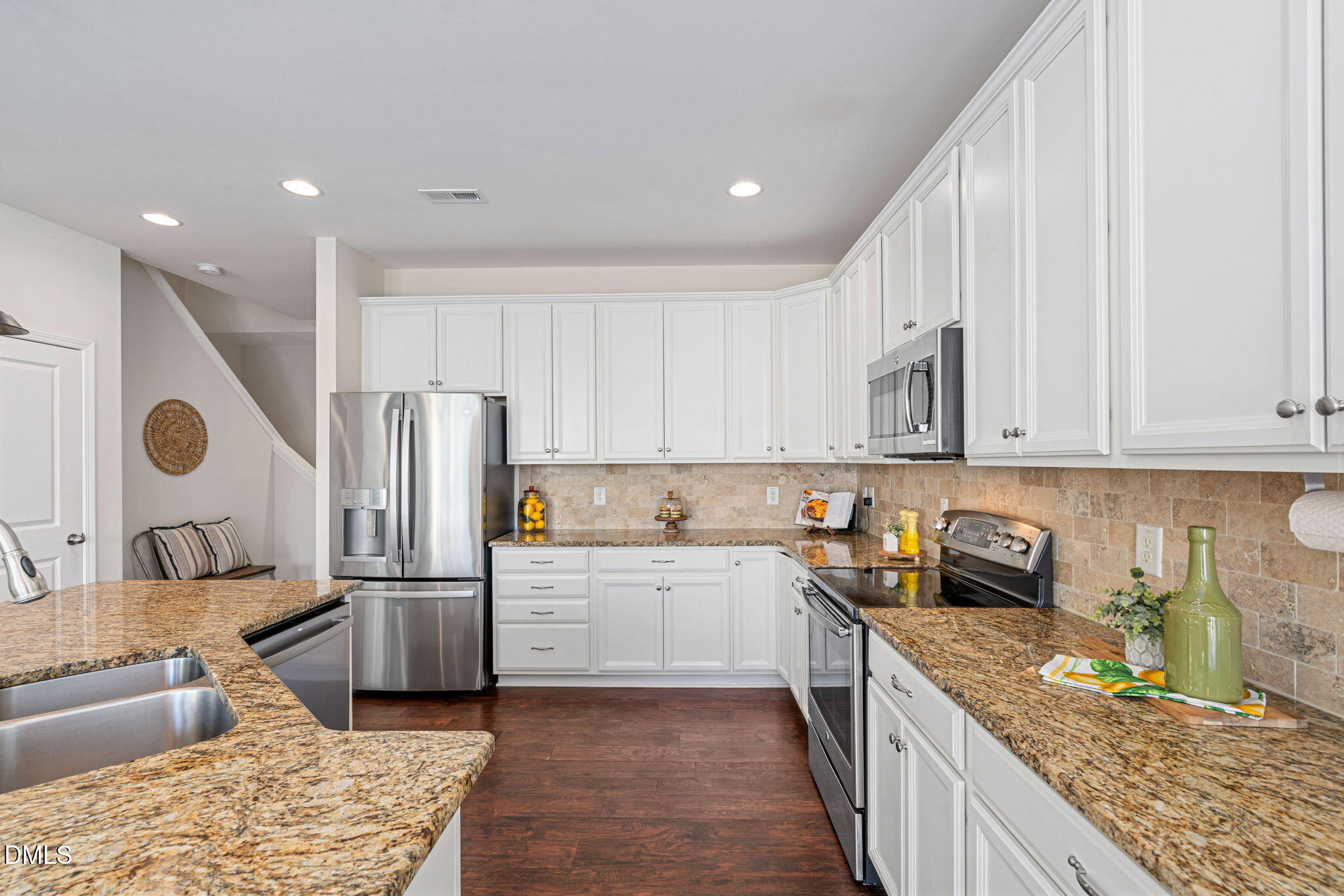 107 Ransomwood Drive Apex, NC 27539 - Photo 16 of 42 a kitchen with stainless steel appliances granite countertop a refrigerator sink and cabinets
