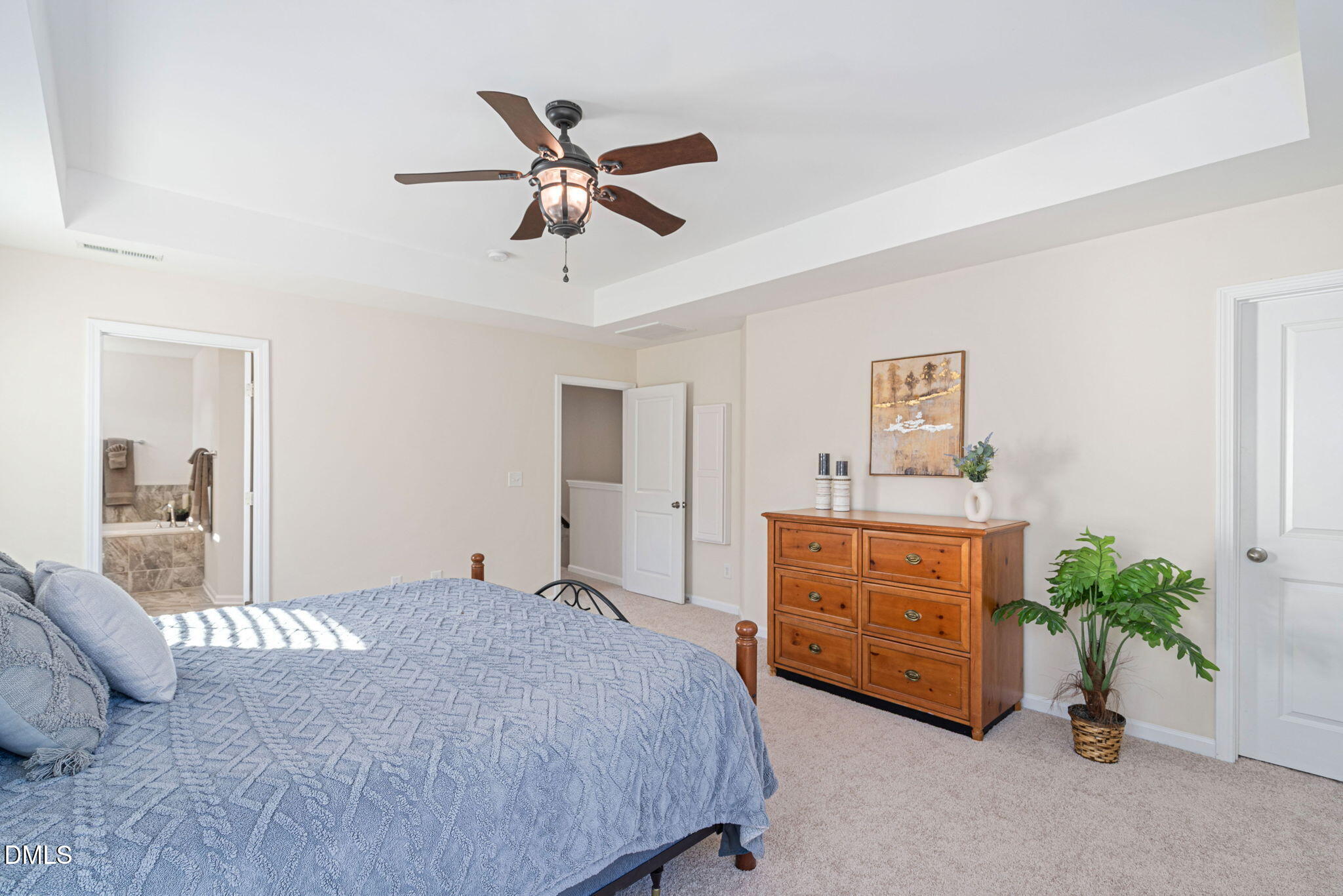 107 Ransomwood Drive Apex, NC 27539 - Photo 25 of 42 a bedroom with a bed and a potted plant