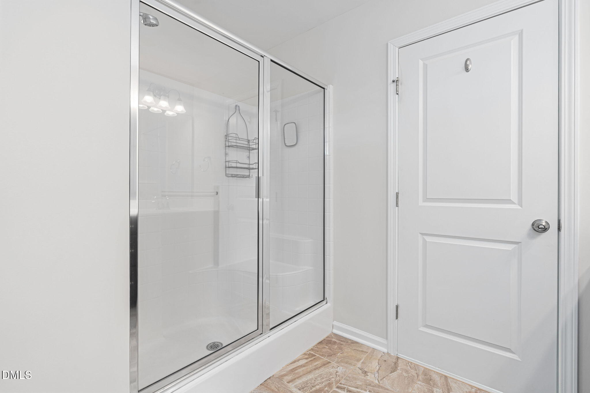 107 Ransomwood Drive Apex, NC 27539 - Photo 28 of 42 a bathroom with a glass shower door