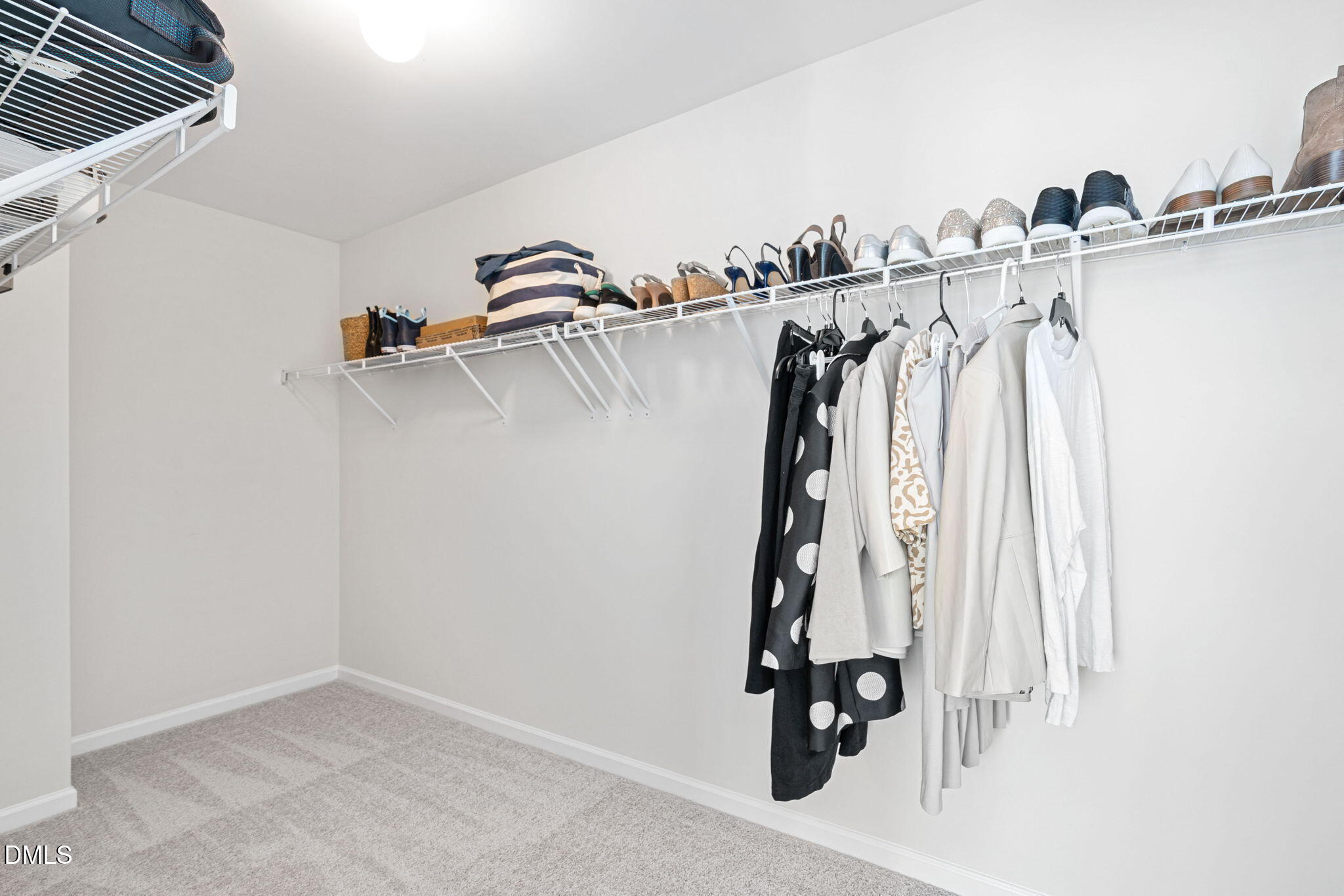 107 Ransomwood Drive Apex, NC 27539 - Photo 30 of 42 a view of walk in closet with clothes and shoes