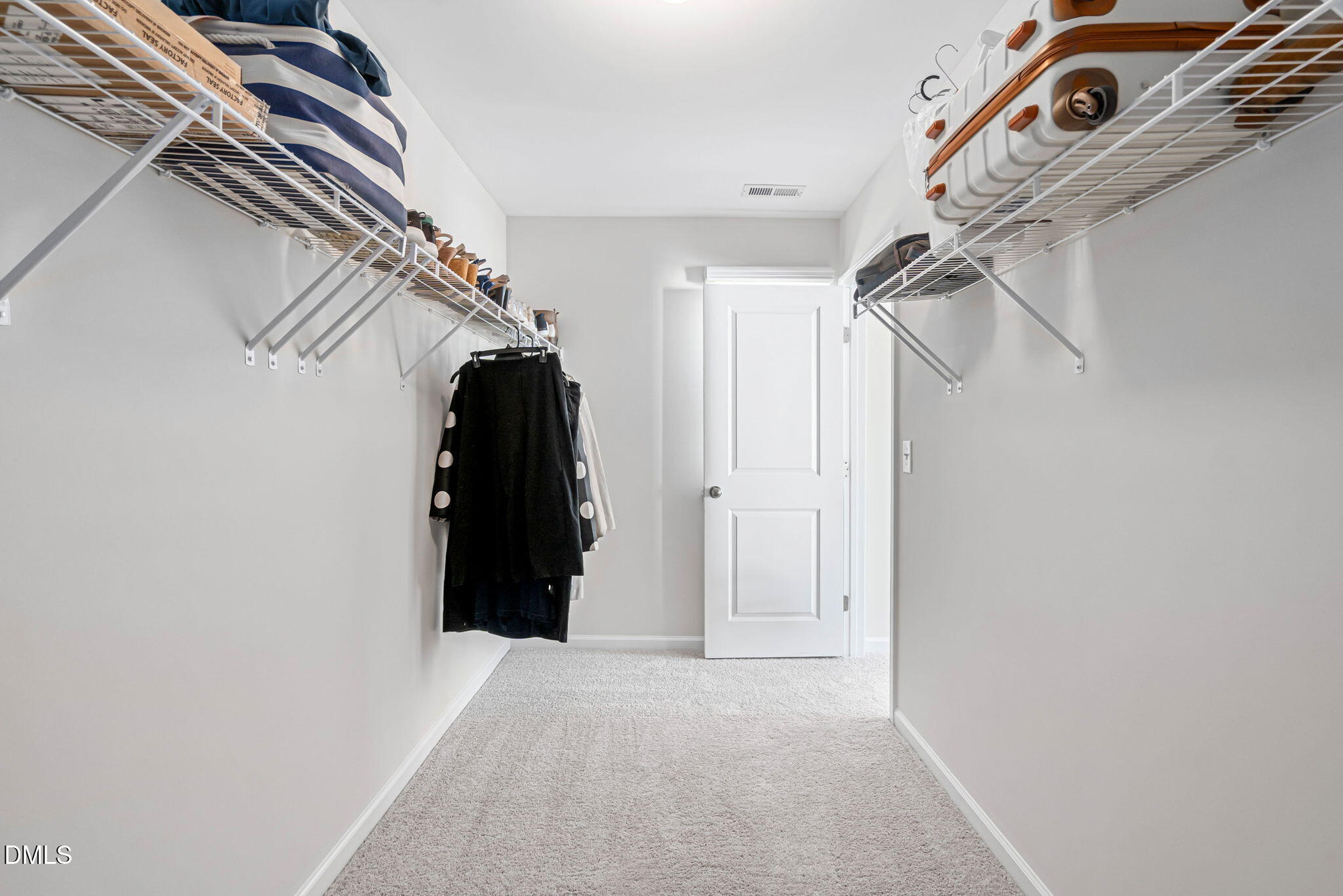 107 Ransomwood Drive Apex, NC 27539 - Photo 31 of 42 a view of walk in closet with clothes