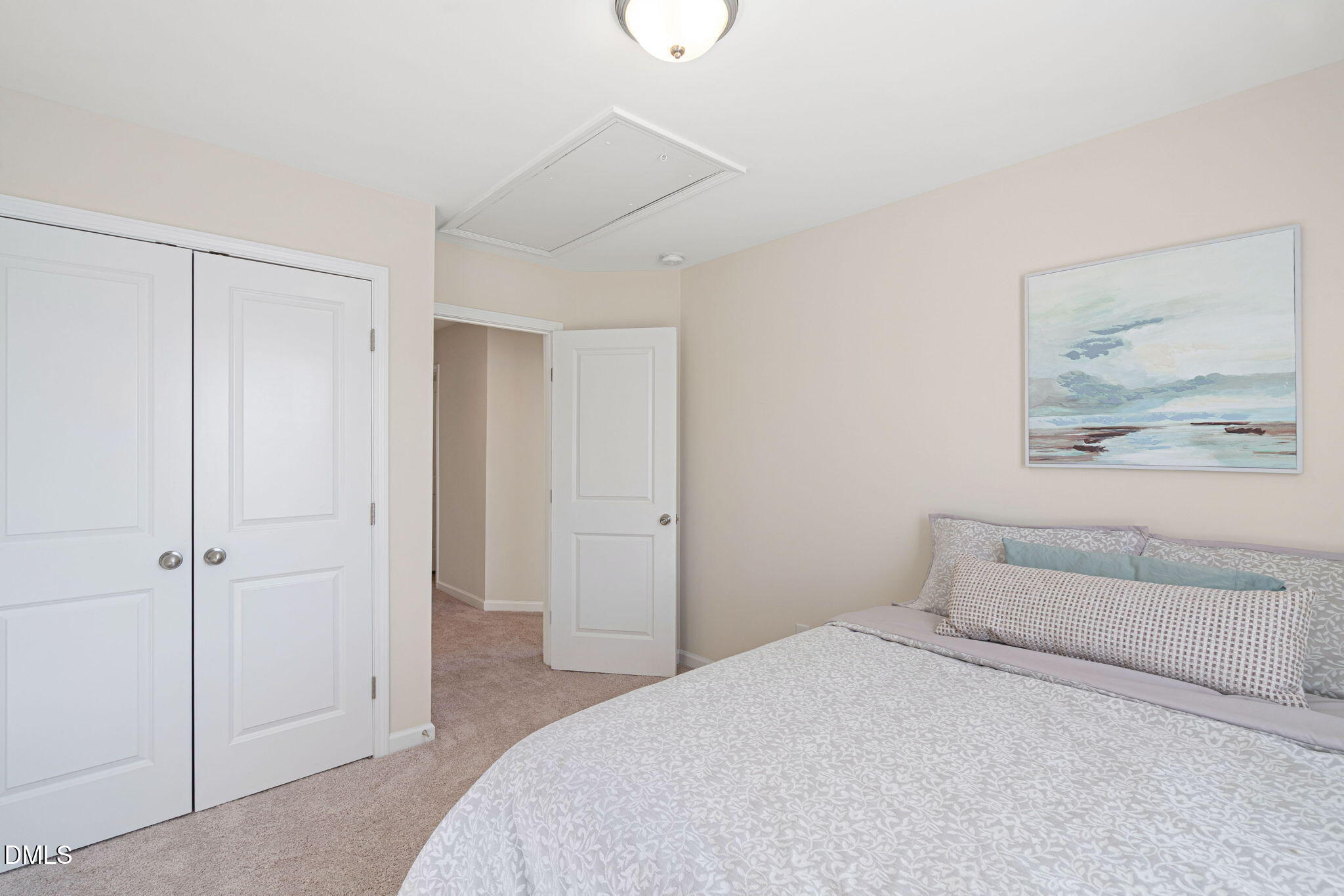 107 Ransomwood Drive Apex, NC 27539 - Photo 33 of 42 a bedroom with a bed and a painting on the wall