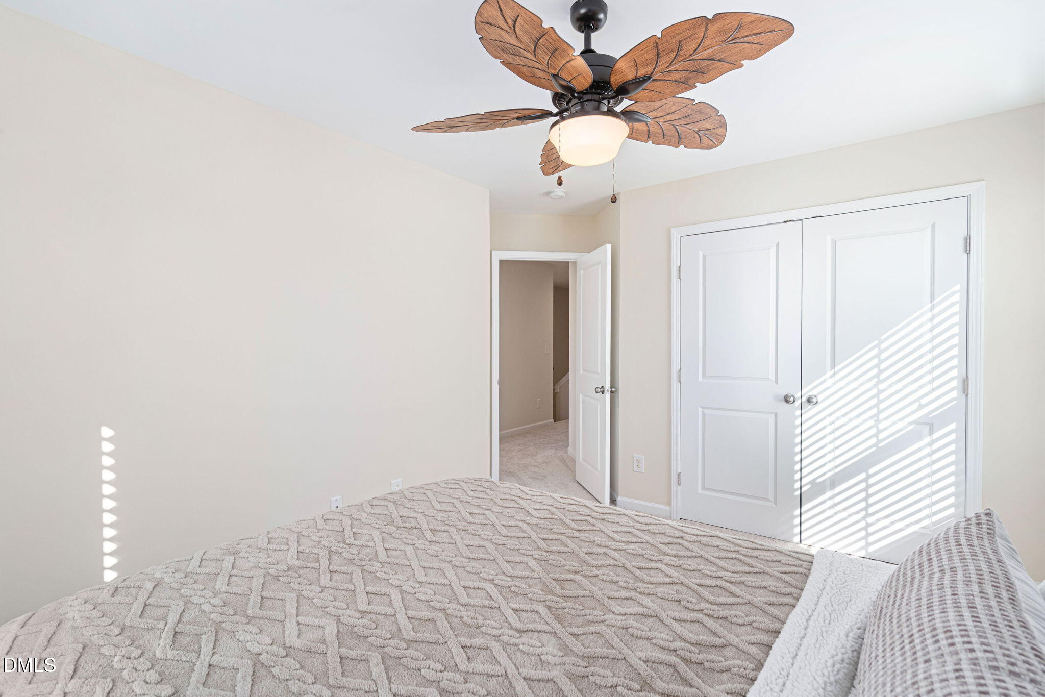 107 Ransomwood Drive Apex, NC 27539 - Photo 35 of 42 a view of a hallway with a chandelier fan and a bathroom