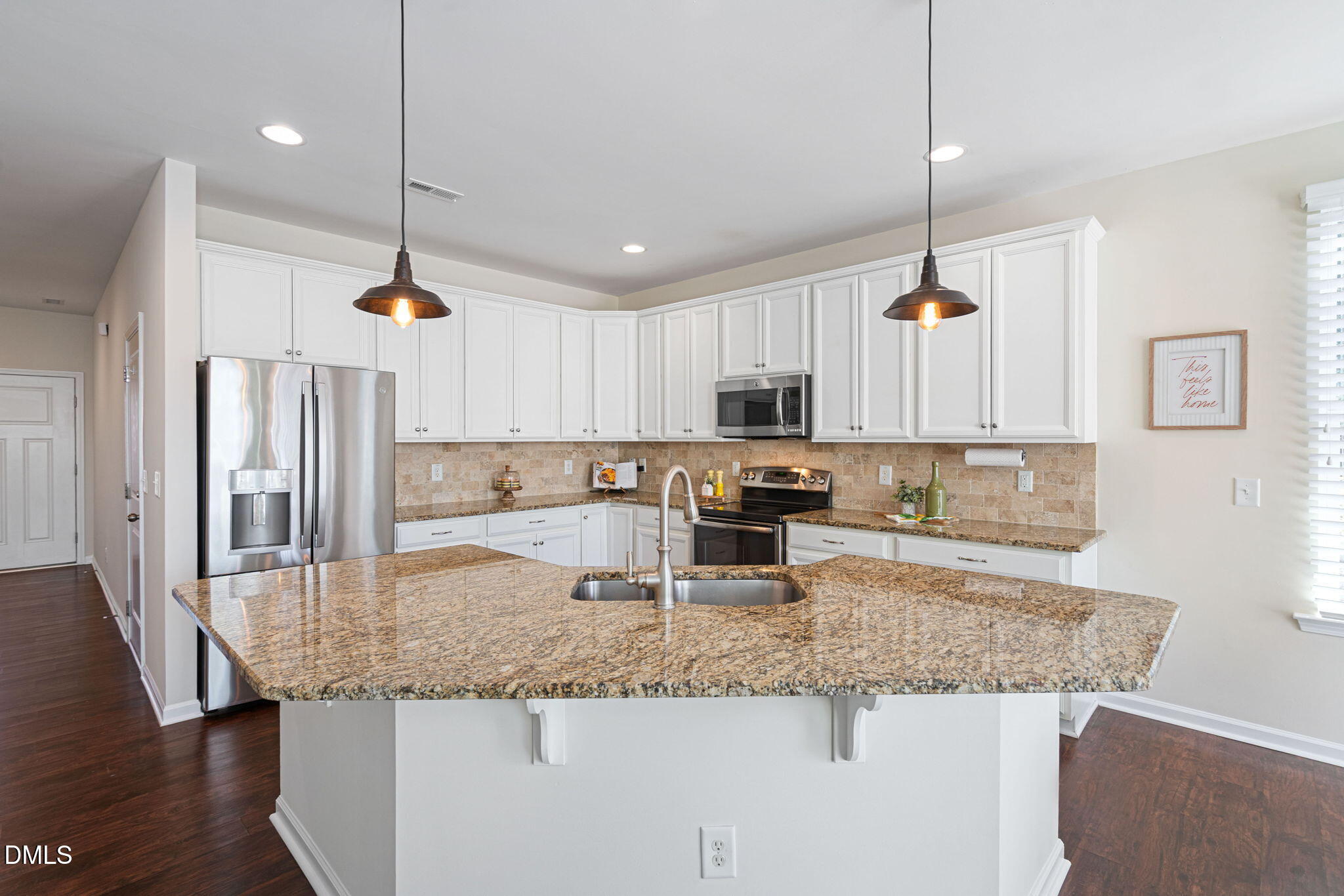 107 Ransomwood Drive Apex, NC 27539 - Photo 4 of 42 a kitchen with stainless steel appliances granite countertop a sink a stove and oven
