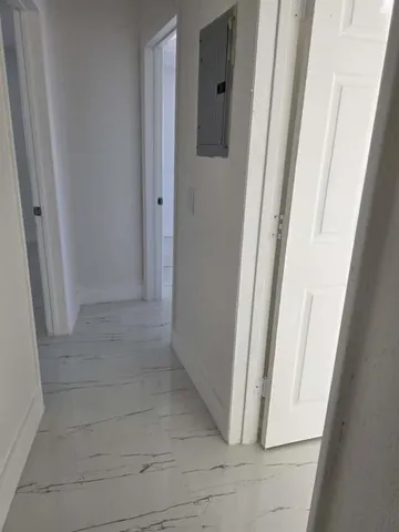 a room with wooden cabinets and a stove top oven