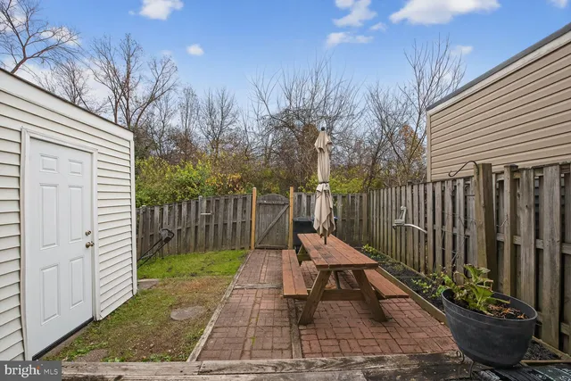 a view of a deck with a chair and floor to ceiling window