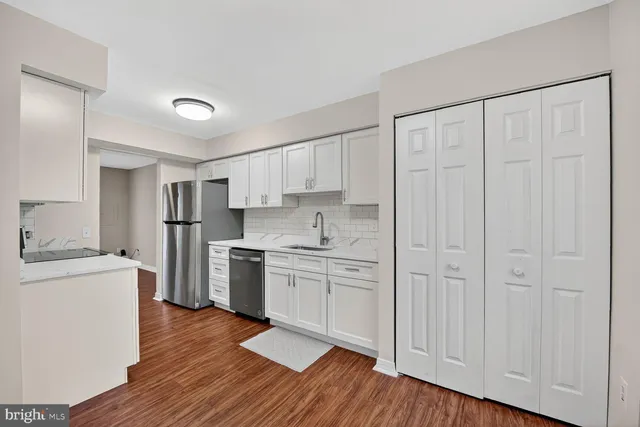 a kitchen with stainless steel appliances a refrigerator and a stove top oven