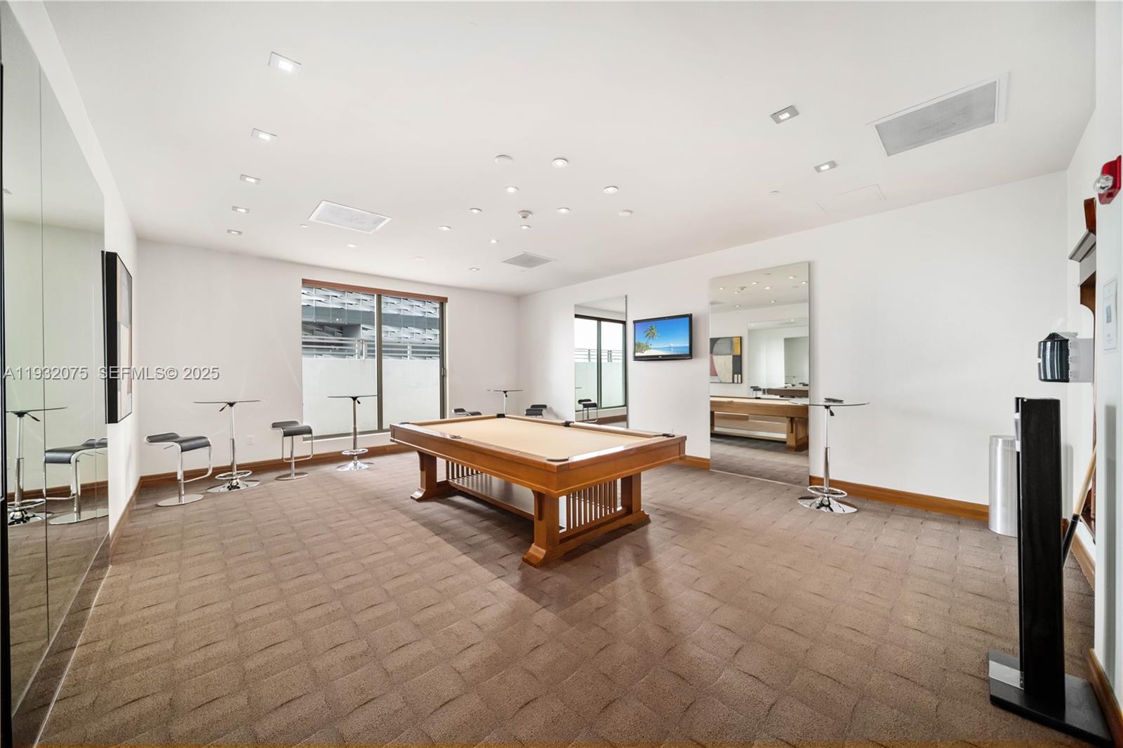 1050 Brickell Avenue, Unit 3122 Miami, FL 33131 - Photo 30 of 31 a living room with furniture pool table and windows