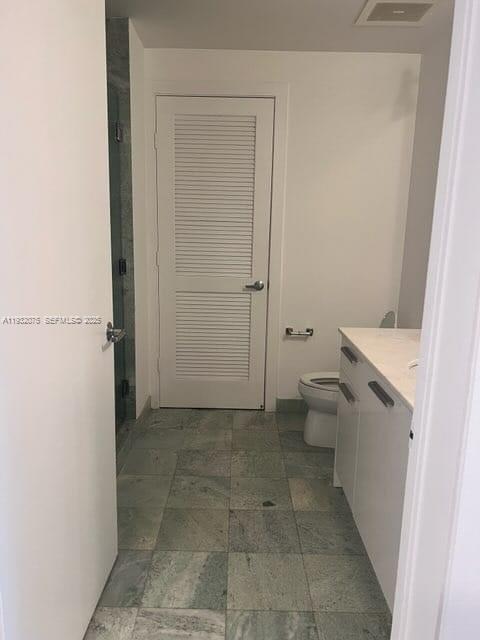 1050 Brickell Avenue, Unit 3122 Miami, FL 33131 - Photo 8 of 31 a bathroom with a granite countertop toilet and a shower