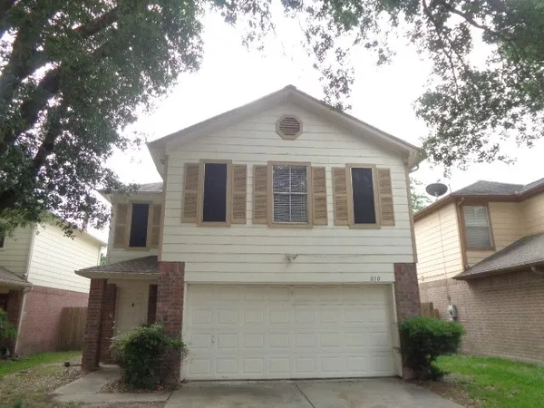 a front view of a house with a garage