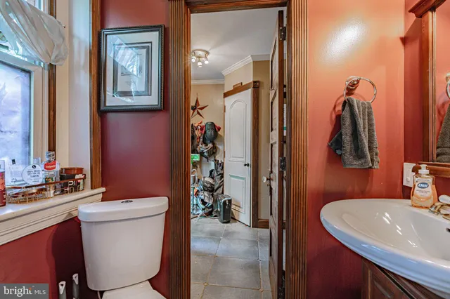 a living room with furniture a flat screen tv and a wooden floor