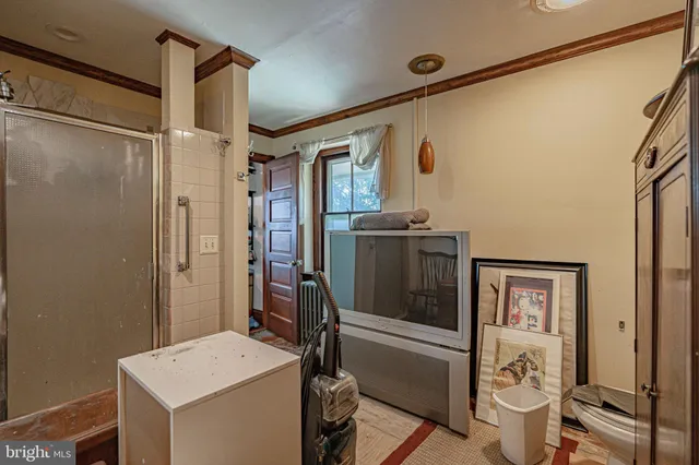 a bedroom with furniture and a large window