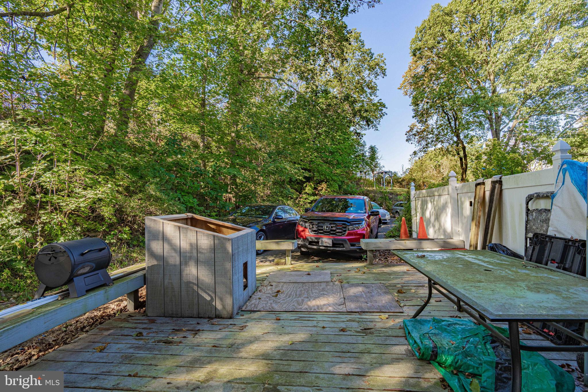 6230 Main Street Center Valley, PA 18034 - Photo 28 of 33 a view of a backyard with couches plants and large trees