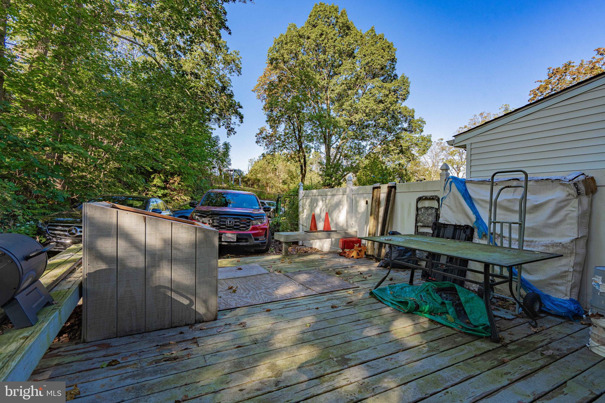 6230 Main Street Center Valley, PA 18034 - Photo 29 of 33 a view of a roof deck with table and chairs a barbeque with wooden floor and fence