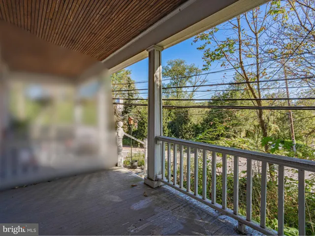 a view of a porch with a table and chairs