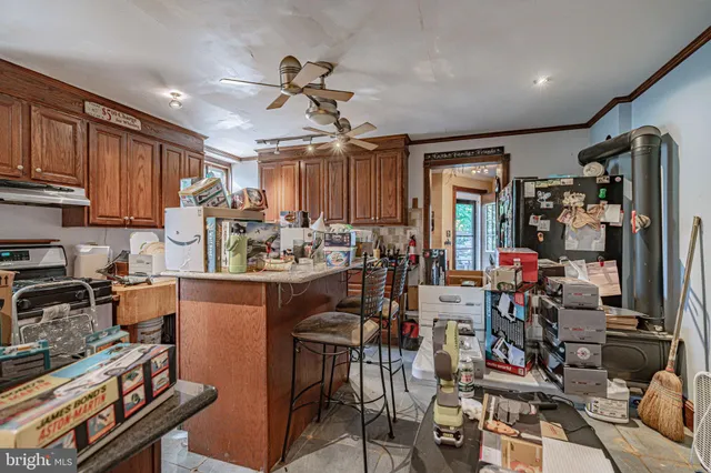 a view of a kitchen with chair and cabinets