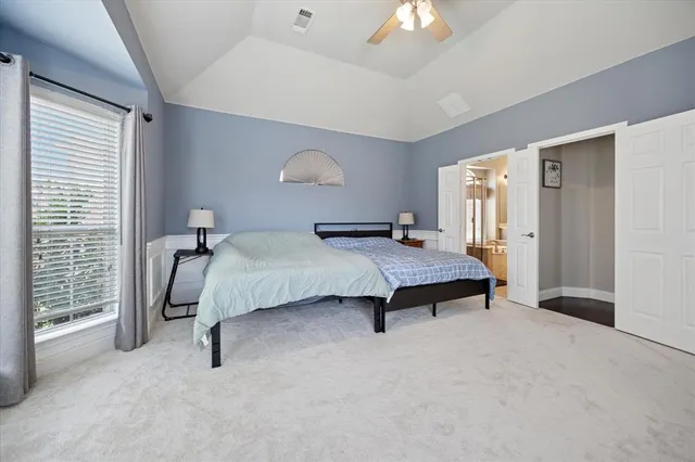 a bedroom with a bed and a large window