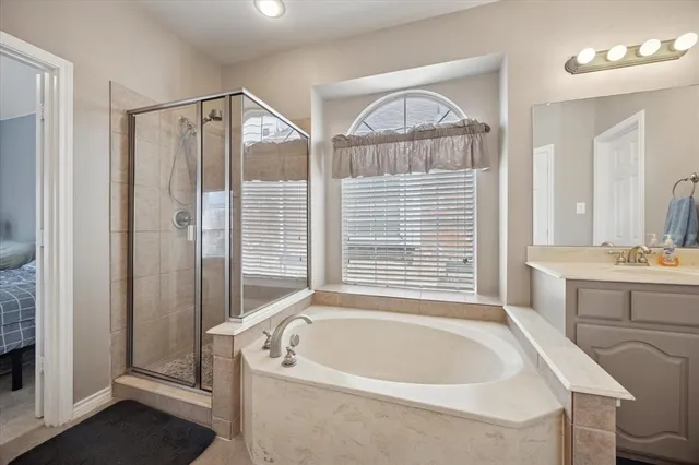 a bathroom with a bathtub and shower