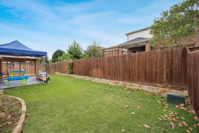 a view of a house with a yard and deck