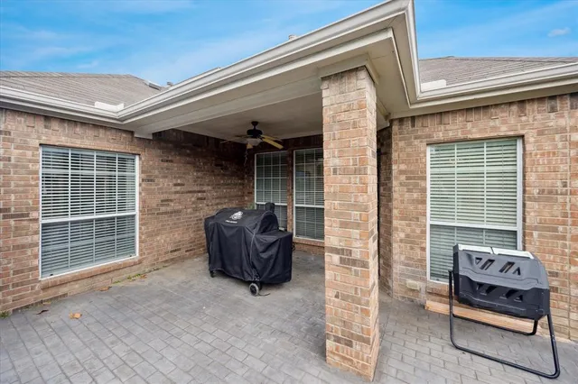 a backyard of a house with table and chairs