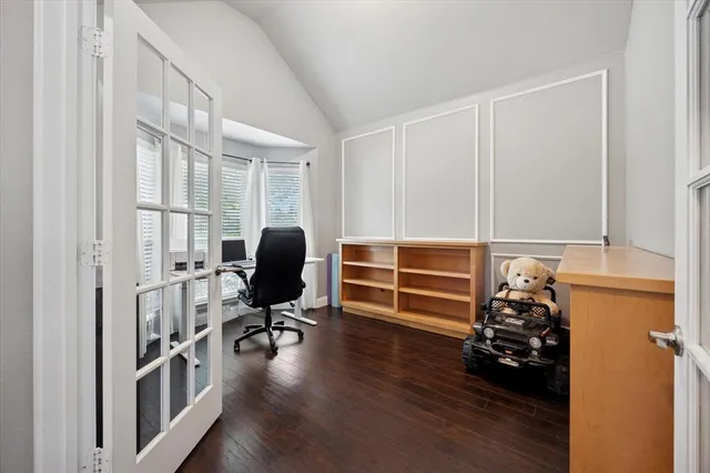 a view of a workspace with furniture and a window