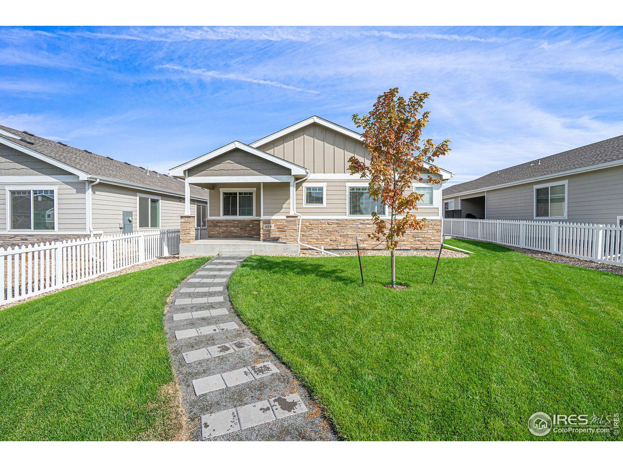 a view of a house with a yard and porch