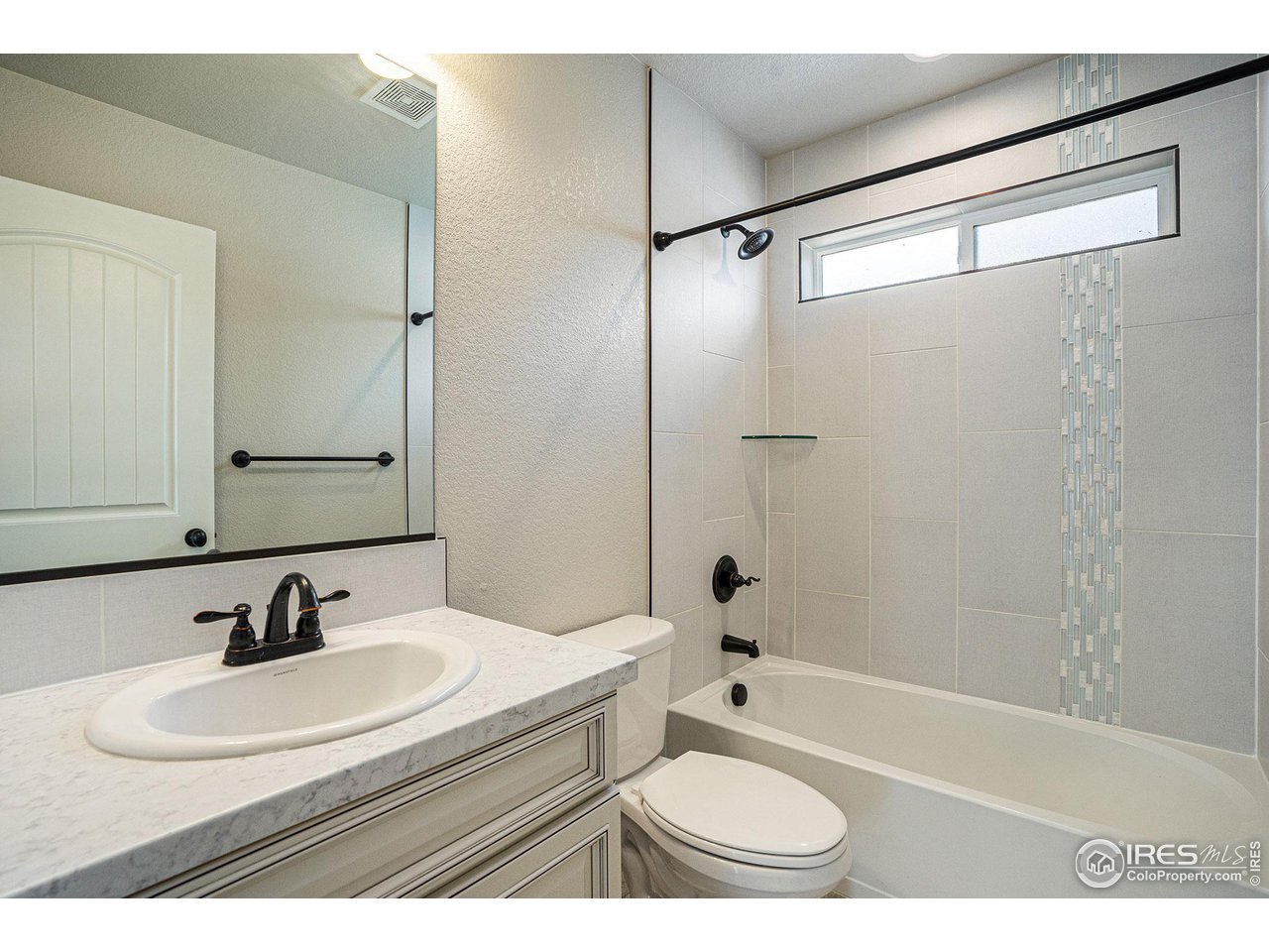 619 Davis Drive Frederick, CO 80530 - Photo 16 of 24 a bathroom with a sink toilet a shower and a bathtub