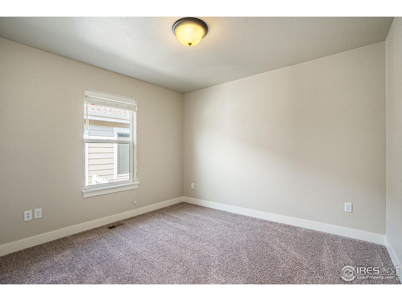 619 Davis Drive Frederick, CO 80530 - Photo 17 of 24 a view of an empty room with a window