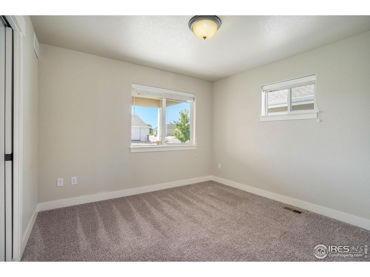 619 Davis Drive Frederick, CO 80530 - Photo 19 of 24 an empty room with windows
