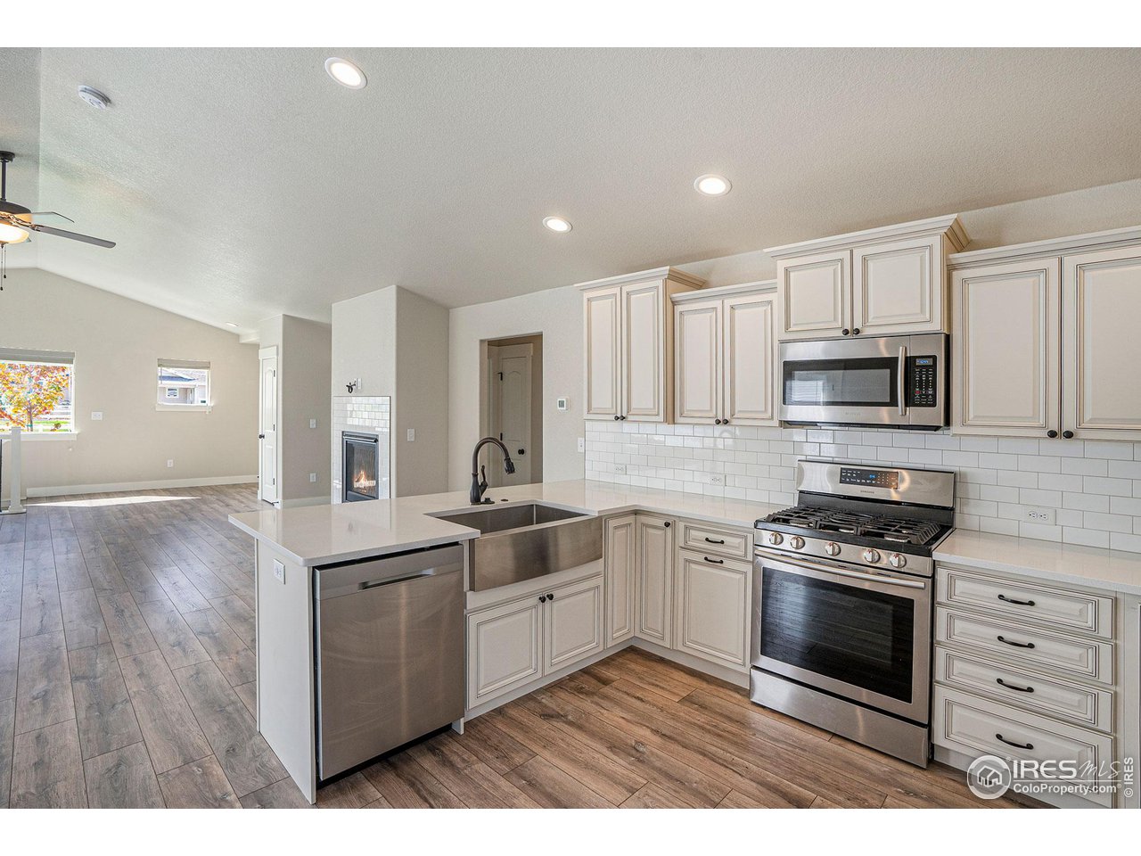 619 Davis Drive Frederick, CO 80530 - Photo 3 of 24 a kitchen with stainless steel appliances a stove sink and cabinets