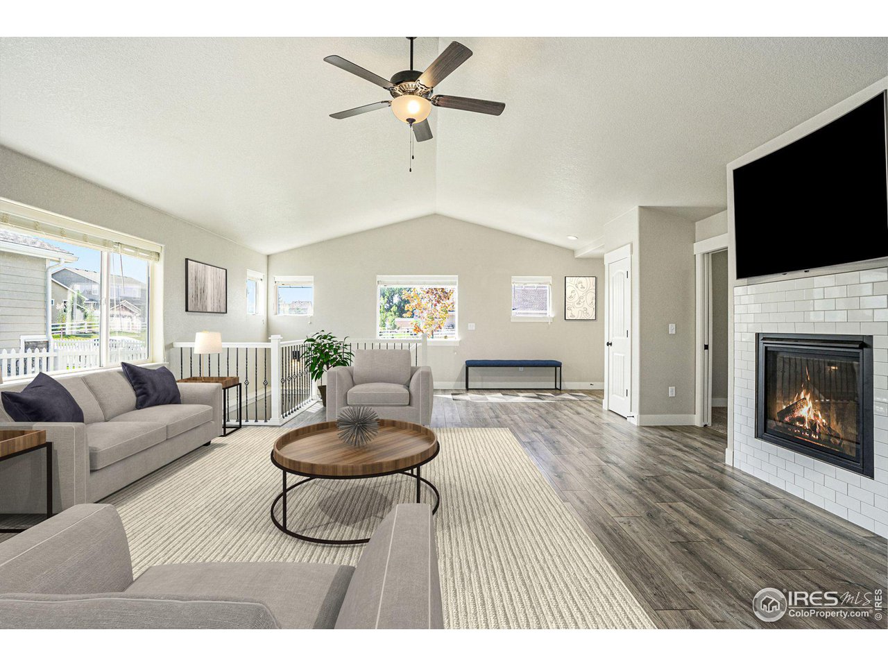 619 Davis Drive Frederick, CO 80530 - Photo 8 of 24 a living room with furniture a flat screen tv and a fireplace