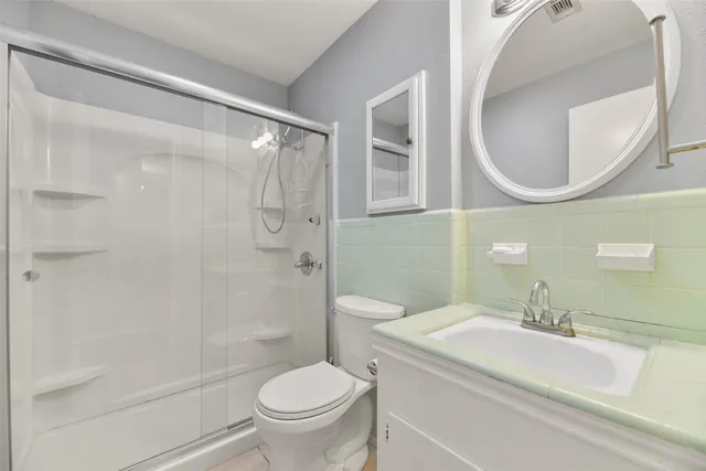 a bathroom with a sink toilet and shower