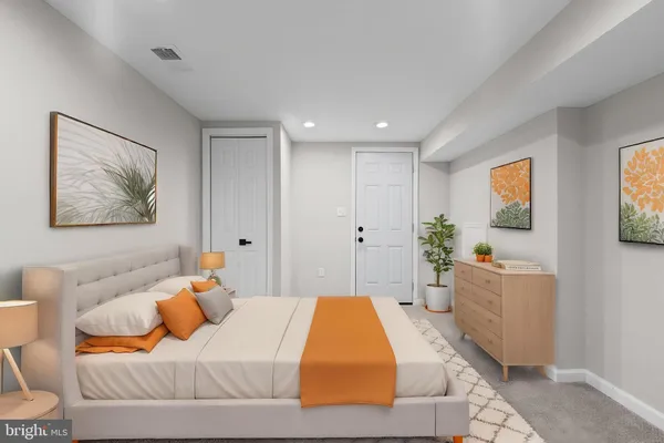 a bedroom with a bed and a couch