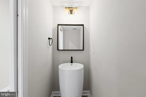 a bathroom with a sink and mirror