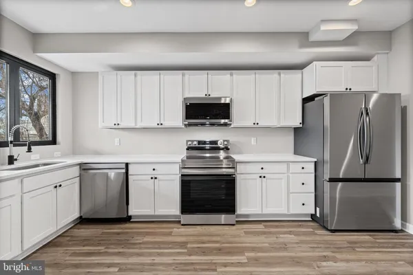 a kitchen with a stove a sink and a refrigerator
