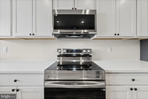a stove top oven sitting inside of a kitchen