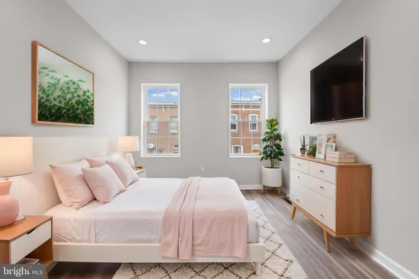 a bedroom with a large bed and a flat screen television