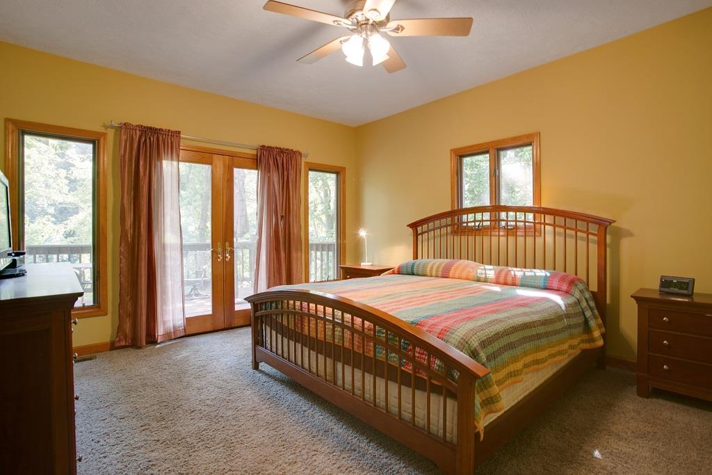 2144 Ridgeview Run Lynchburg, TN 37352 - Photo 16 of 29 a bedroom with a bed and a chandelier