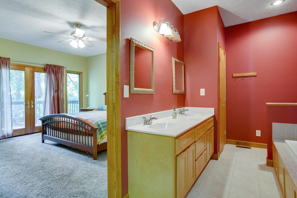 2144 Ridgeview Run Lynchburg, TN 37352 - Photo 18 of 29 a en suite bathroom with a sink a vanity and a mirror
