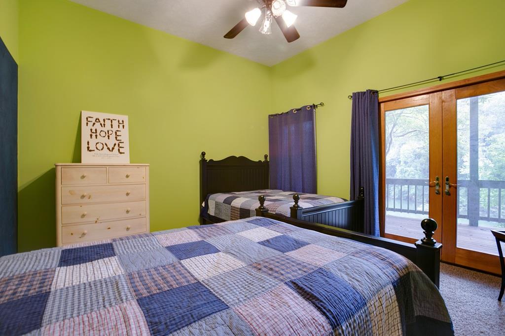 2144 Ridgeview Run Lynchburg, TN 37352 - Photo 26 of 29 a bedroom with a bed and a chandelier