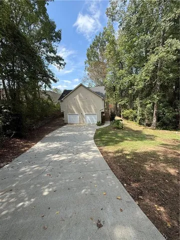 a view of a yard with large trees