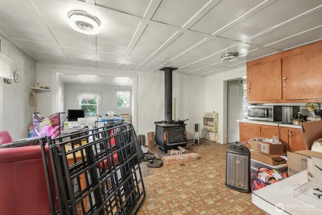 a living room with a stove and a window