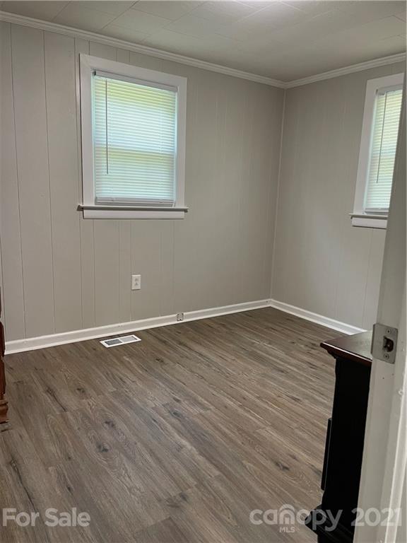 1027 Capps Road Bessemer City, NC 28016 - Photo 14 of 20 a view of an empty room with wooden floor and a window
