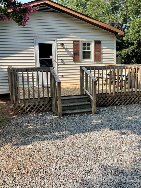 1027 Capps Road Bessemer City, NC 28016 - Photo 16 of 20 a view of a house with a yard and wooden fence