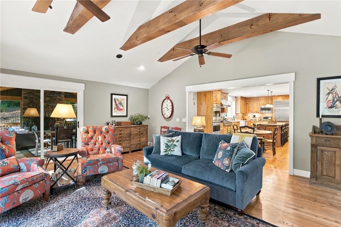 604 Ridgecrest Drive Clemson, SC 29631 - Photo 26 of 50 Gleaming hardwood floors and rustic exposed beams define this spacious, light-filled living area.