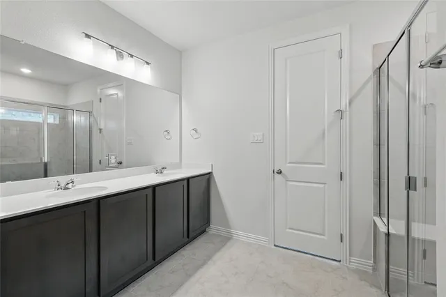 a view of bathroom with a sink mirror and a shower