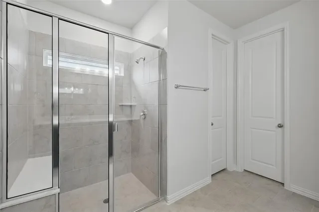 a bathroom with a glass shower door